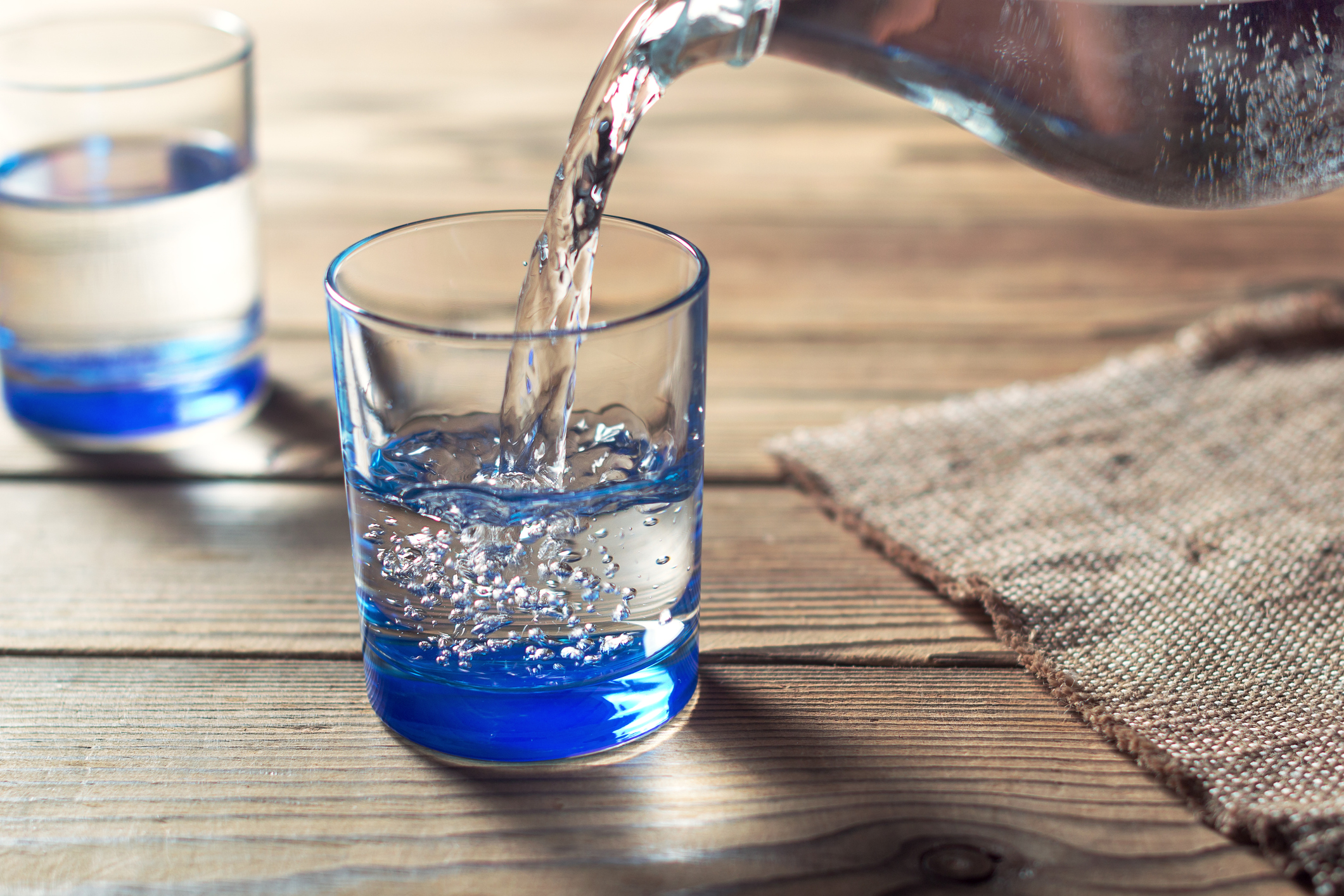 Glasses of water on a wooden table. Water was poured into the beaker. Selective focus. Shallow DOF