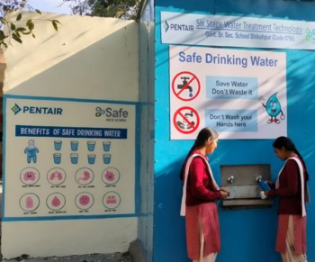 image of two girls at safe water network shikophur school with pentair branding
